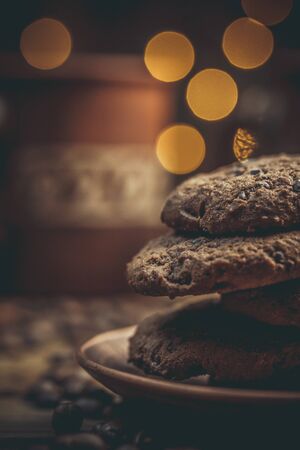 Cups and cups with coffee, coffee grains and gingerbread cookies nearby for refreshments in warm...