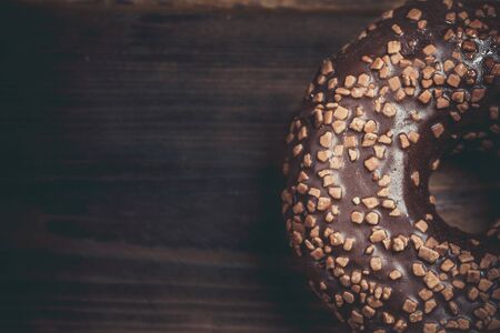 Chocolate donut and chocolate on a wooden table in warm colorの写真素材