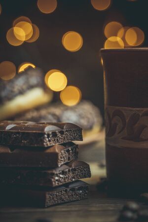 Delicious donuts with chocolate and a cup of coffee in warm colors.の写真素材