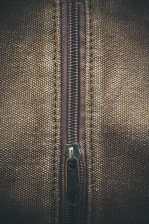 Thick khaki fabric and zipper on it in macroの写真素材