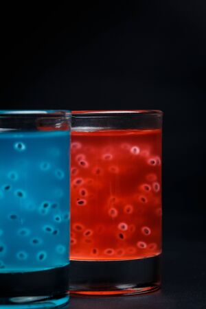 Red and blue cocktail on a black backgroundの写真素材