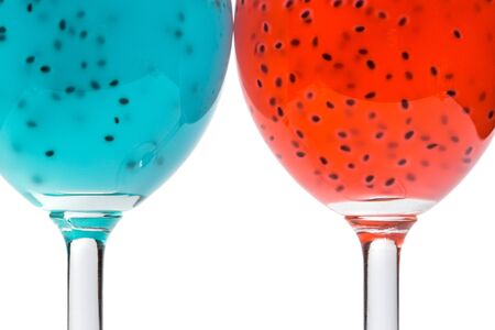 Red and turquoise cocktail with grains on a whiteの写真素材