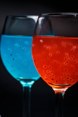Red and blue cocktail on a black backgroundの写真素材