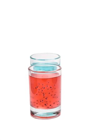 Red and turquoise cocktail with grains on a whiteの写真素材