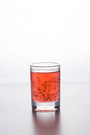 Tasty red cocktail with grains on a white backgroundの写真素材