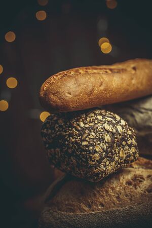 Different loaves of bread cooked with flour and gluten-free wheat on a wooden table