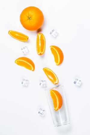 Fresh oranges in a glass cup on a white backgroundの写真素材
