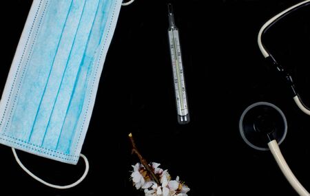 Medical mask for protection against viruses on a black backgroundの写真素材