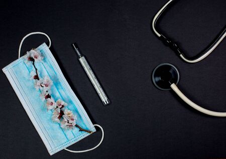 Medical mask for protection against viruses on a black backgroundの写真素材