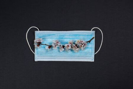 Medical mask for protection against viruses on a black backgroundの写真素材