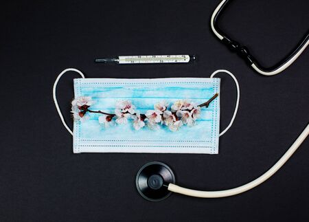 Medical mask for protection against viruses on a black backgroundの写真素材