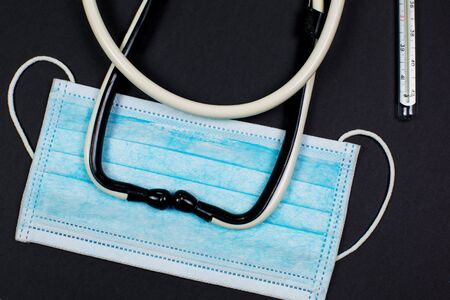 Medical mask for protection against viruses on a black backgroundの写真素材