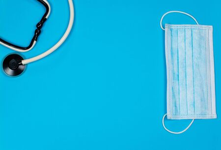 Medical mask for protection against viruses on a blue backgroundの写真素材