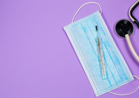 Medical mask for protection against viruses on a purple background