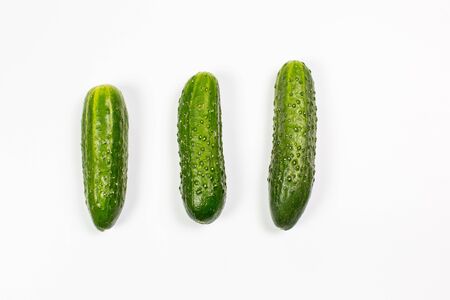 Fresh green cucumbers on a white backgroundの写真素材