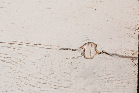 Texture of an old white painted board with scratches and cracksの写真素材