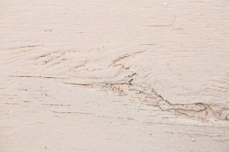 Texture of an old white painted board with scratches and cracksの写真素材