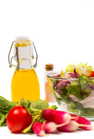 Fresh spring vegetables, salad, spices on a white backgroundの写真素材