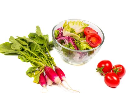 Fresh spring vegetables, salad, spices on a white backgroundの写真素材