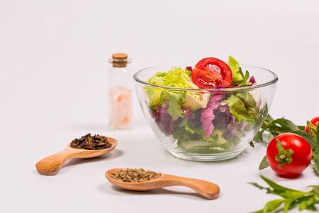 Fresh spring vegetables, salad, spices on a white backgroundの写真素材