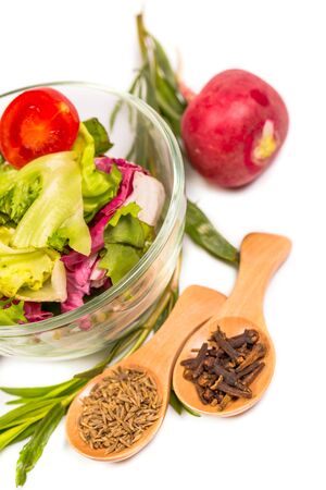 Fresh spring vegetables, salad, spices on a white backgroundの写真素材