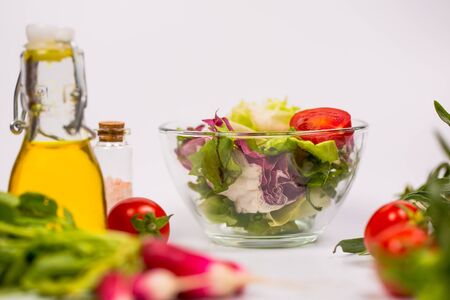 Fresh spring vegetables, salad, spices on a white backgroundの写真素材