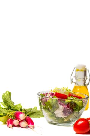 Fresh spring vegetables, salad, spices on a white backgroundの写真素材