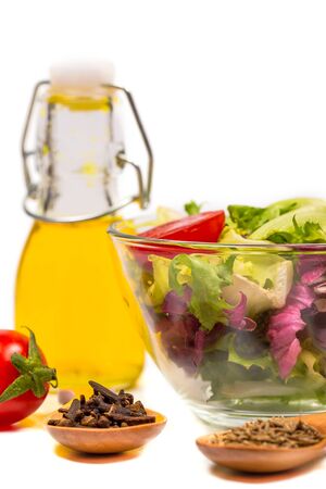 Fresh spring vegetables, salad, spices on a white backgroundの写真素材