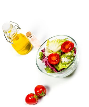 Fresh spring vegetables, salad, spices on a white backgroundの写真素材