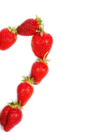 Heart made from red strawberries on a white backgroundの写真素材