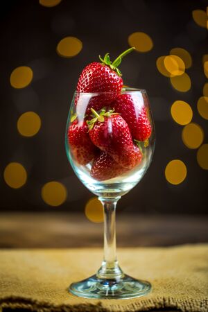 Ripe red strawberries in warm romantic colors with blur background.の写真素材