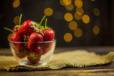 Ripe red strawberries in warm romantic colors with blur background.の写真素材