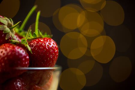 Ripe red strawberries in warm romantic colors with blur background.の写真素材