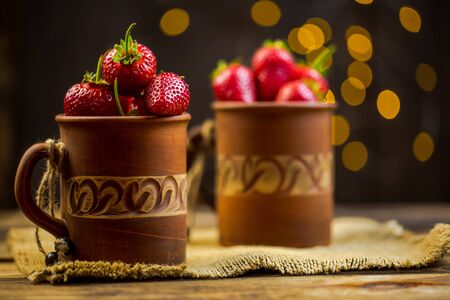 Ripe red strawberries in warm romantic colors with blur background.の写真素材