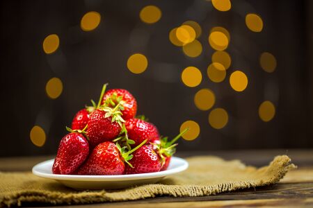Ripe red strawberries in warm romantic colors with blur background.の写真素材