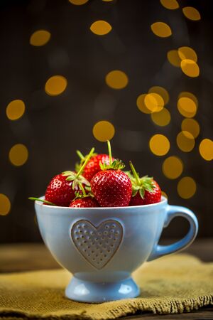 Ripe red strawberries in warm romantic colors with blur background.の写真素材