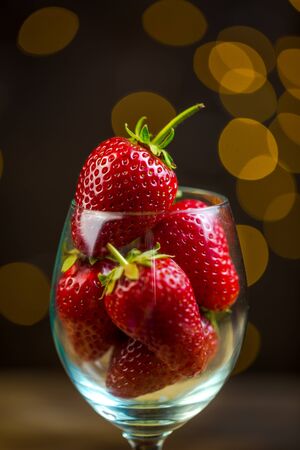 Ripe red strawberries in warm romantic colors with blur background.の写真素材