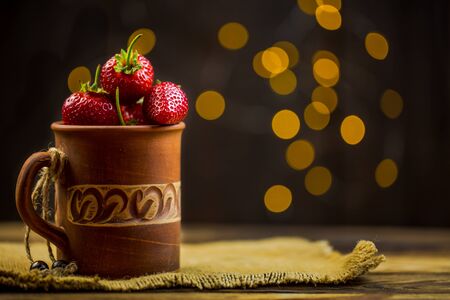 Ripe red strawberries in warm romantic colors with blur background.の写真素材