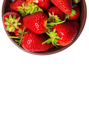 Strawberries on a brown plate on a white backgroundの写真素材