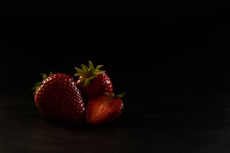 Ripe red strawberries on a black backgroundの写真素材