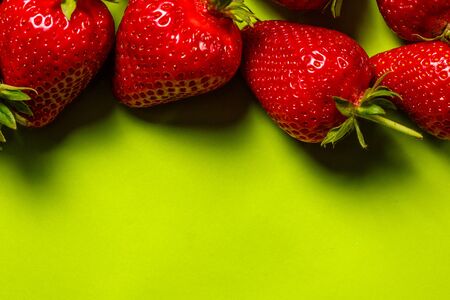 Ripe red strawberries on a green backgroundの写真素材