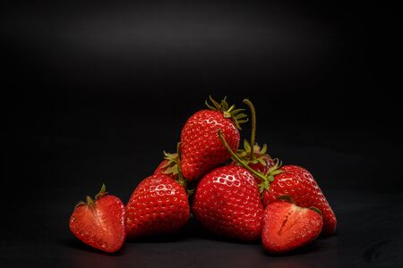 Ripe red strawberries on a black backgroundの写真素材