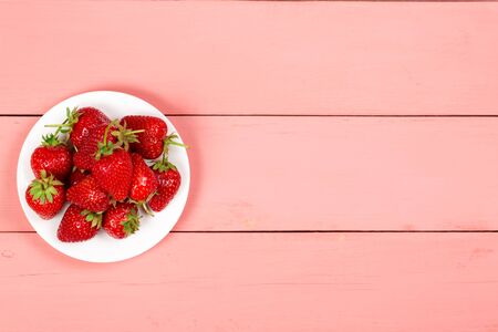 Ripe red strawberries on a pink wooden backgroundの写真素材