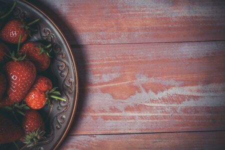Ripe red strawberries on a pink wooden backgroundの写真素材