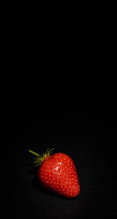 Ripe red strawberries on a black backgroundの写真素材