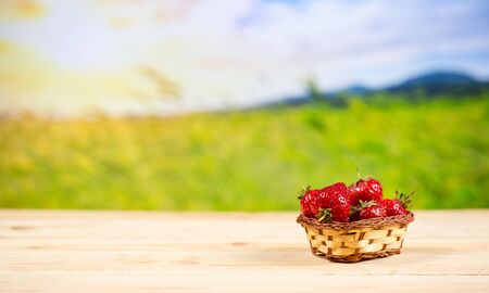 Ripe strawberries in a basket on the tableの写真素材
