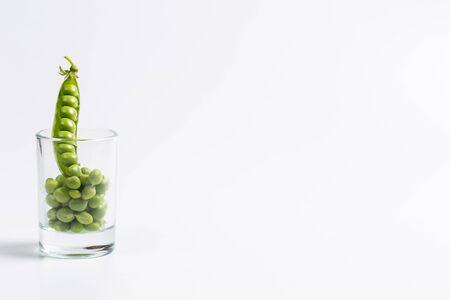 Ripe green peas on a white background, after assembly on the farm
