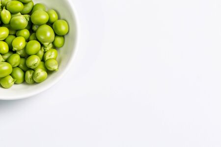 Ripe green peas on a white background, after assembly on the farmの写真素材