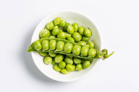 Ripe green peas on a white background, after assembly on the farmの写真素材