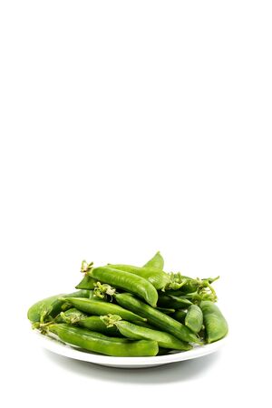 Ripe green peas on a white background, after assembly on the farmの写真素材